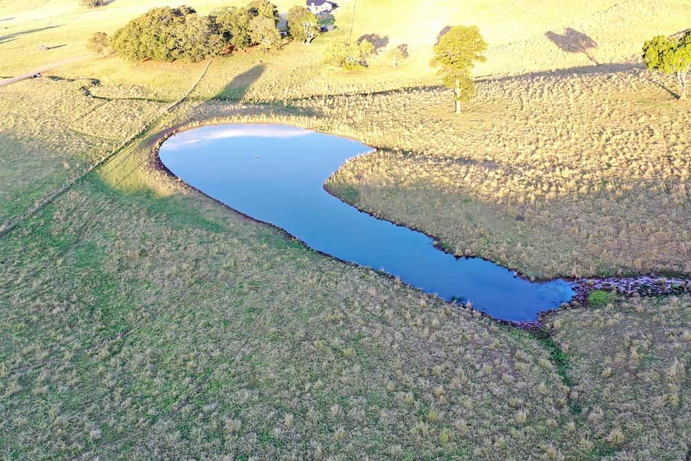 An Aerial View Of A Small Pond In The Middle Of A Field — J & M Bashforth & Sons In Brunswick Heads, NSW