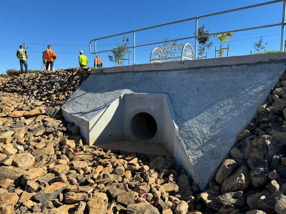 A Group Of People Standing On Top Of A Rocky Hill — J & M Bashforth & Sons In Brunswick Heads, NSW
