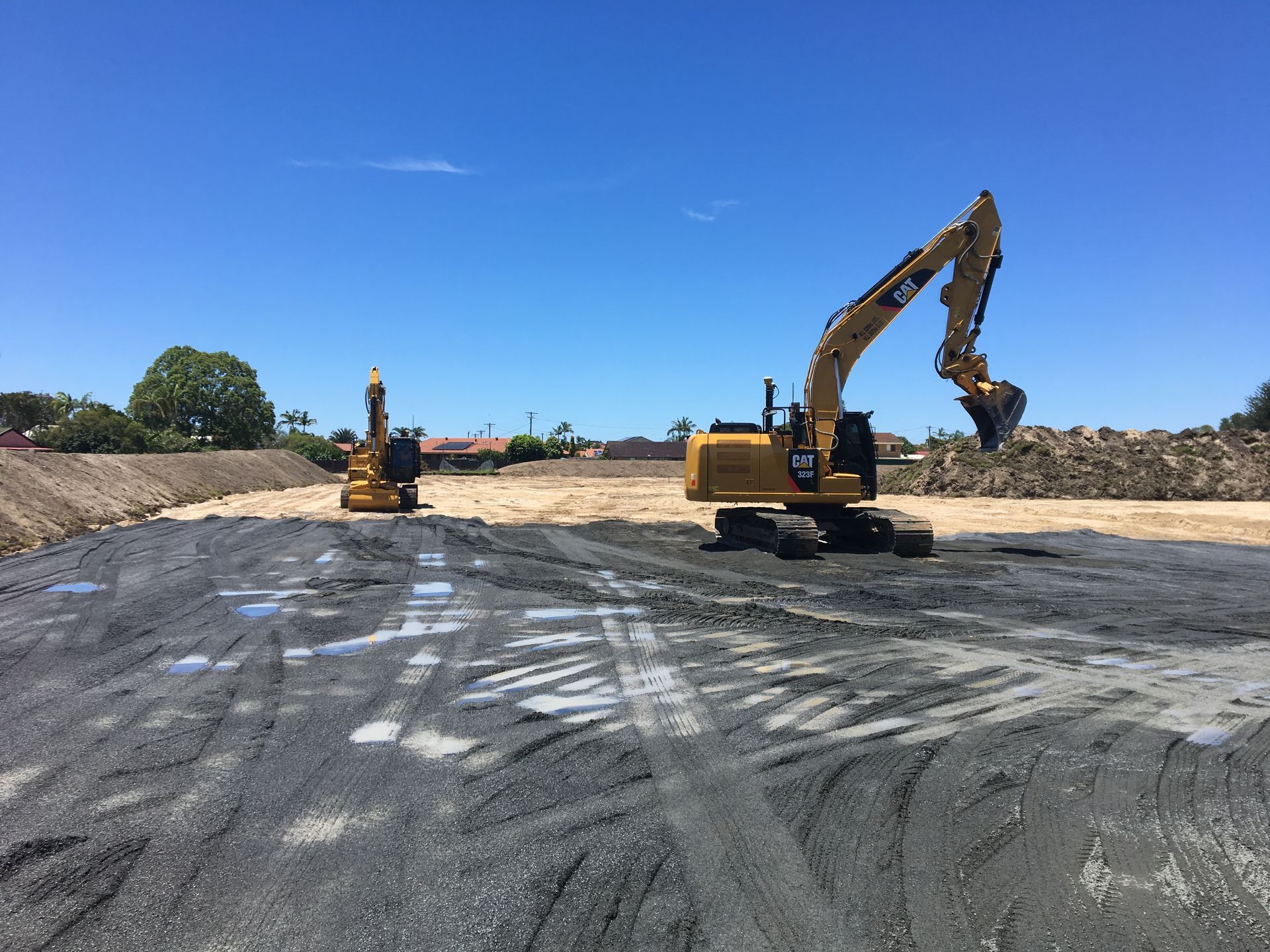 A Couple of Excavators Are Sitting on Top of A Dirt Field — J & M Bashforth & Sons In Murwillumbah, NSW