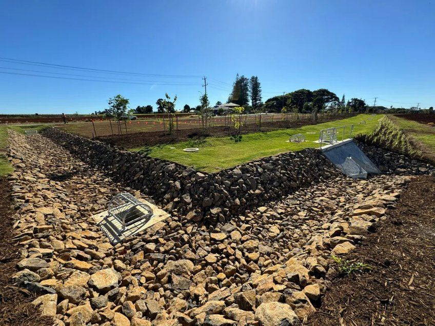 Grass Patch Surrounded By Rocks— J & M Bashforth & Sons In Brunswick Heads, NSW