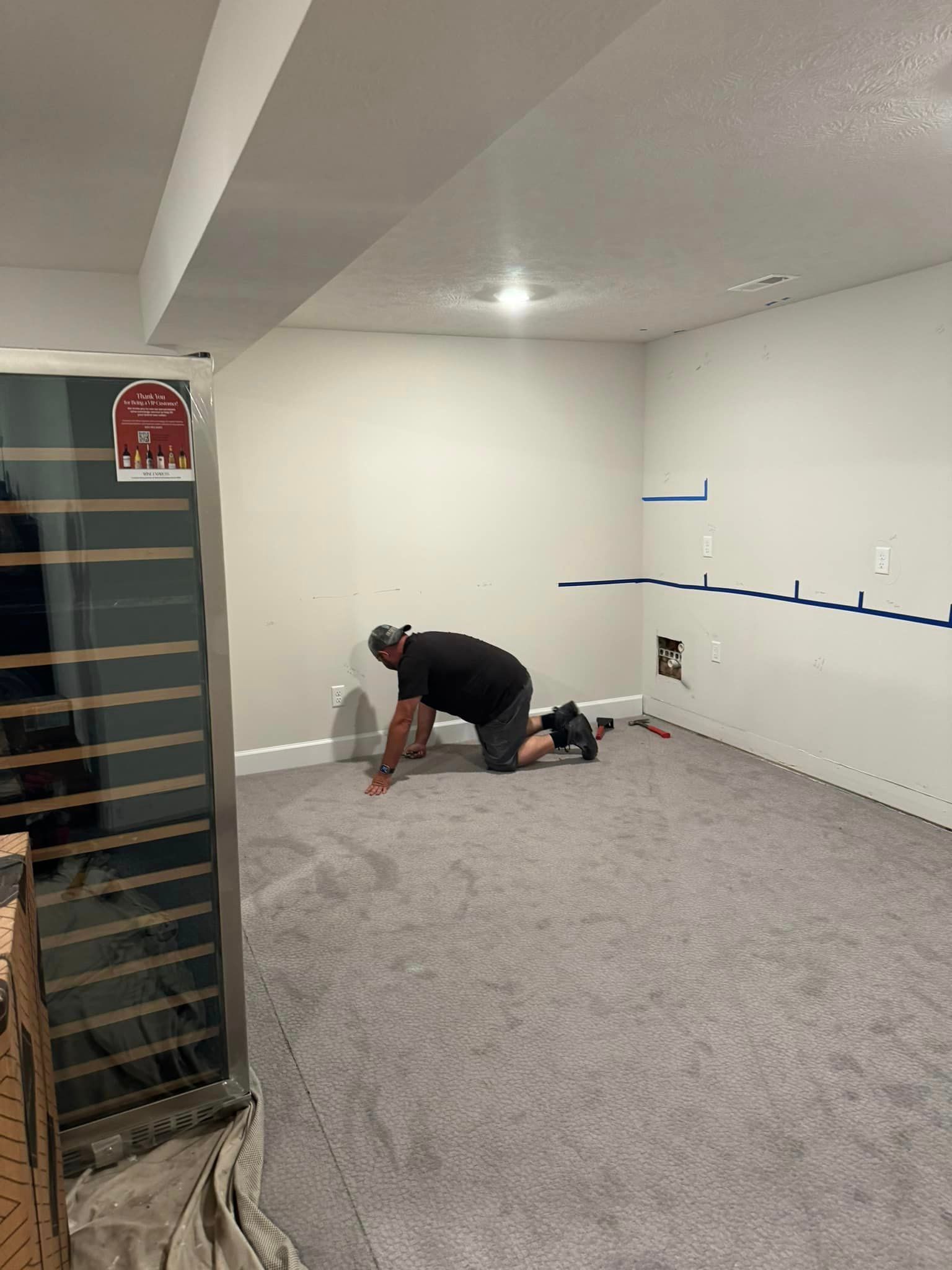 remodeling contractor installs trim in basement