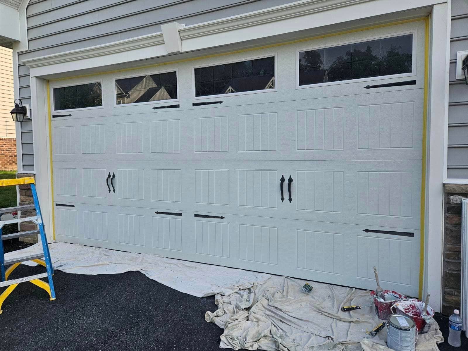 bringer's prepairing to paint garage door