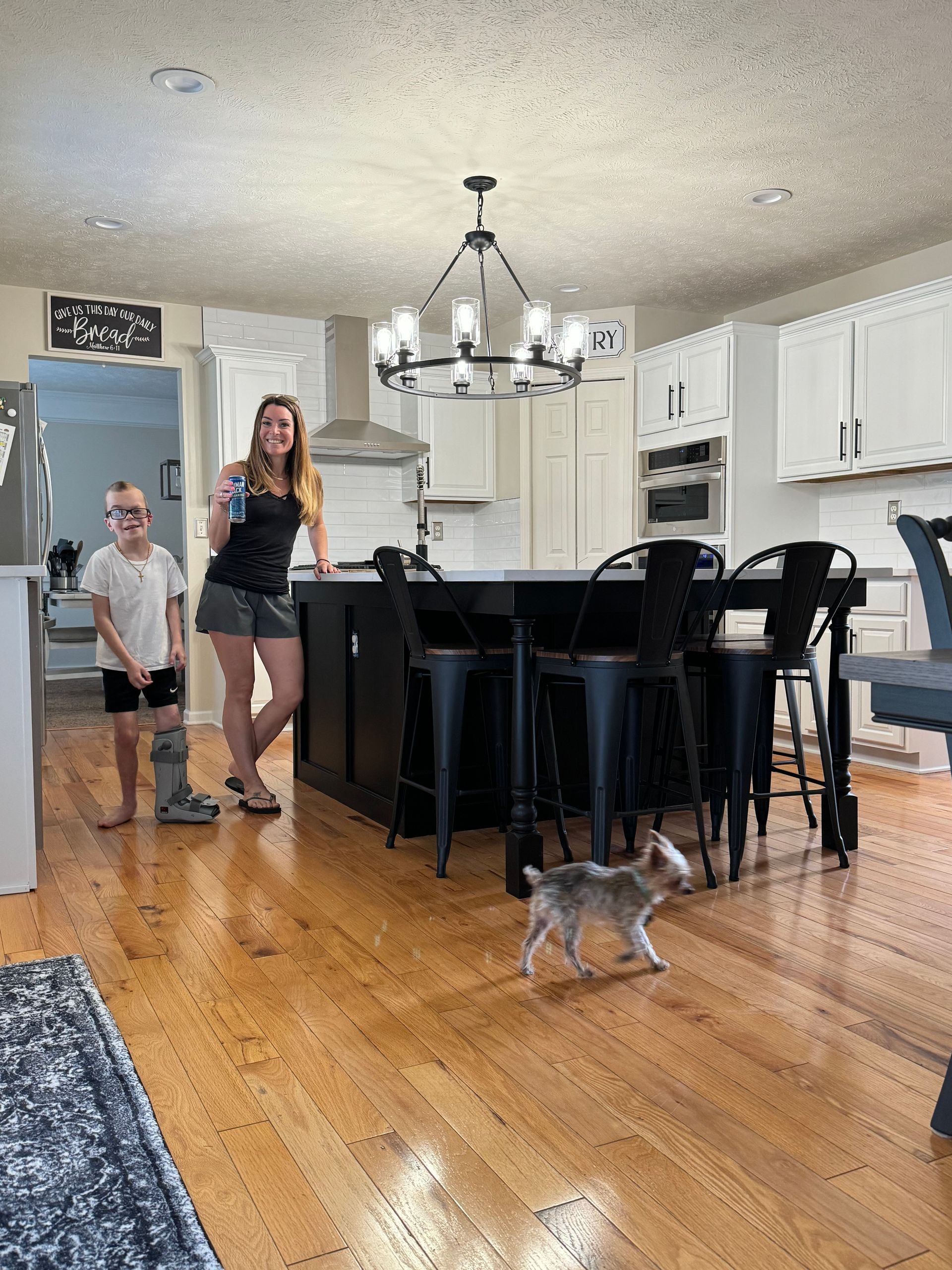 woman and her son posing in their newly remodeled kitchen