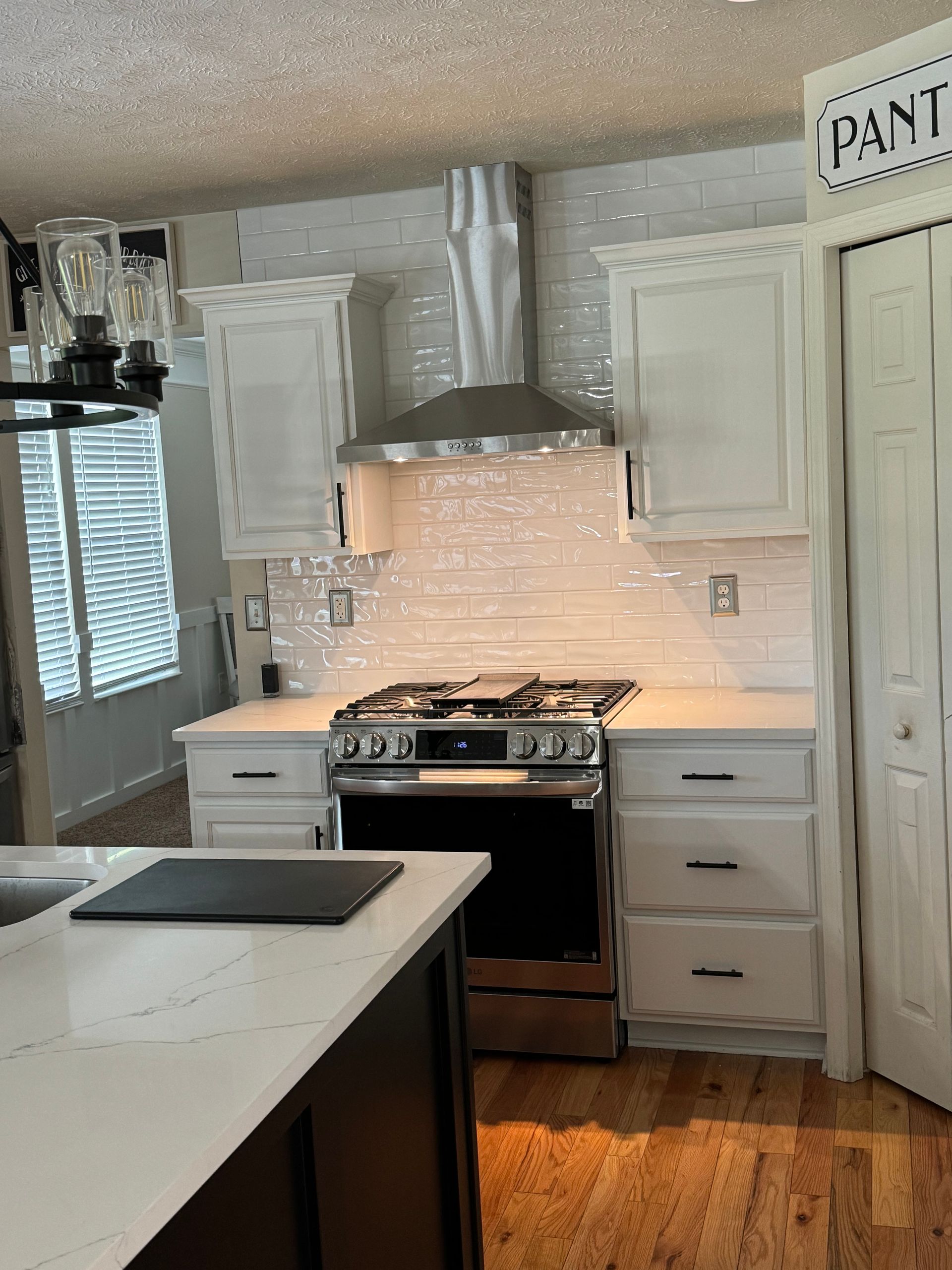 new tile work, cabinets and stove with range hood by Obringer's painting and remodeling