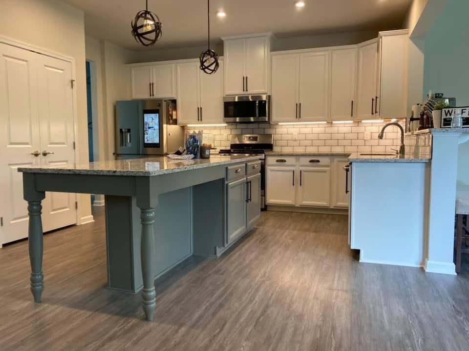kitchen remodeled in venetia by obringers with white cabinets and dark island