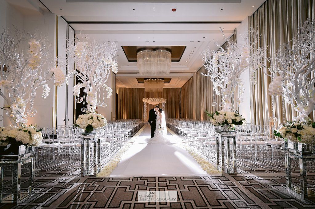A bride and groom are walking down the aisle at a wedding ceremony.