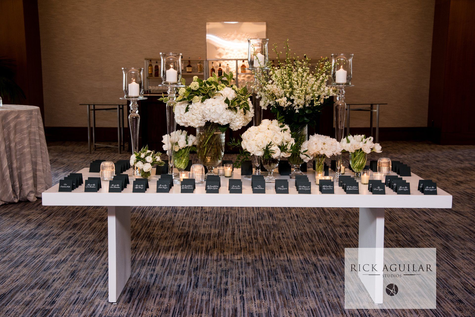 A white table with flowers and candles on it