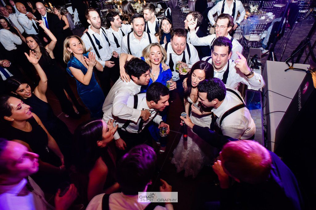 A large group of people are dancing at a party.