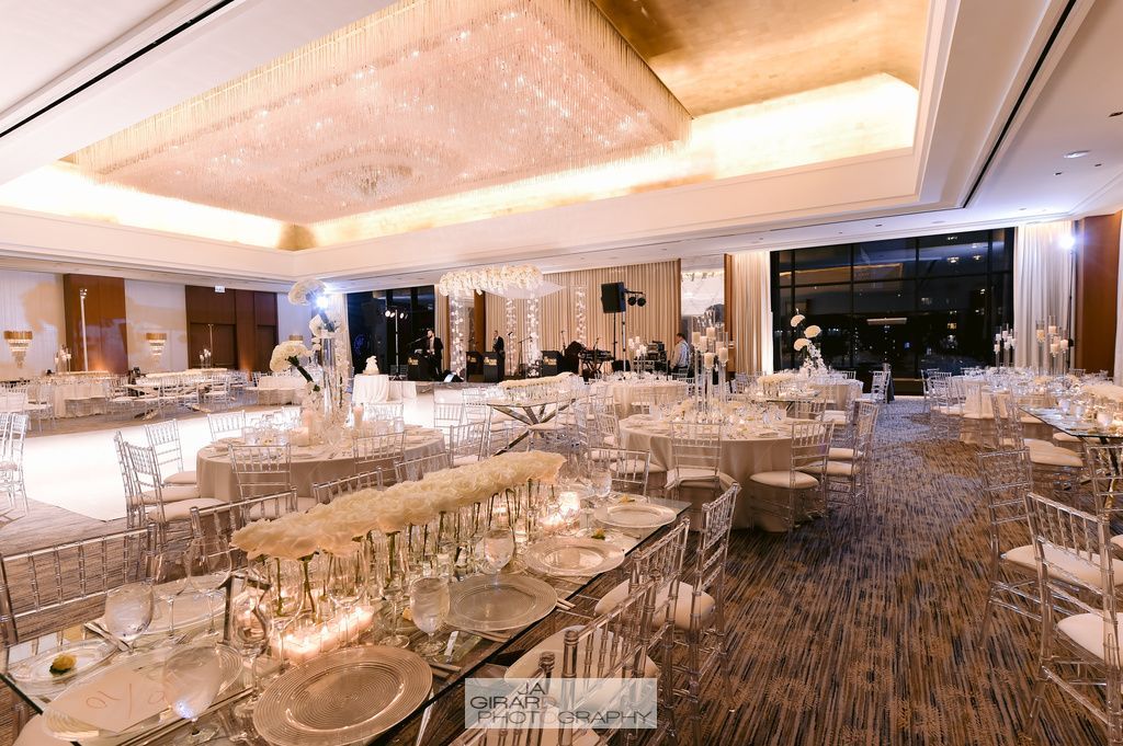 A large room with tables and chairs set up for a wedding reception.