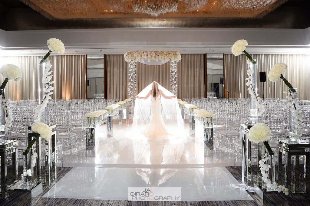 A bride in a wedding dress is walking down the aisle at a wedding ceremony.