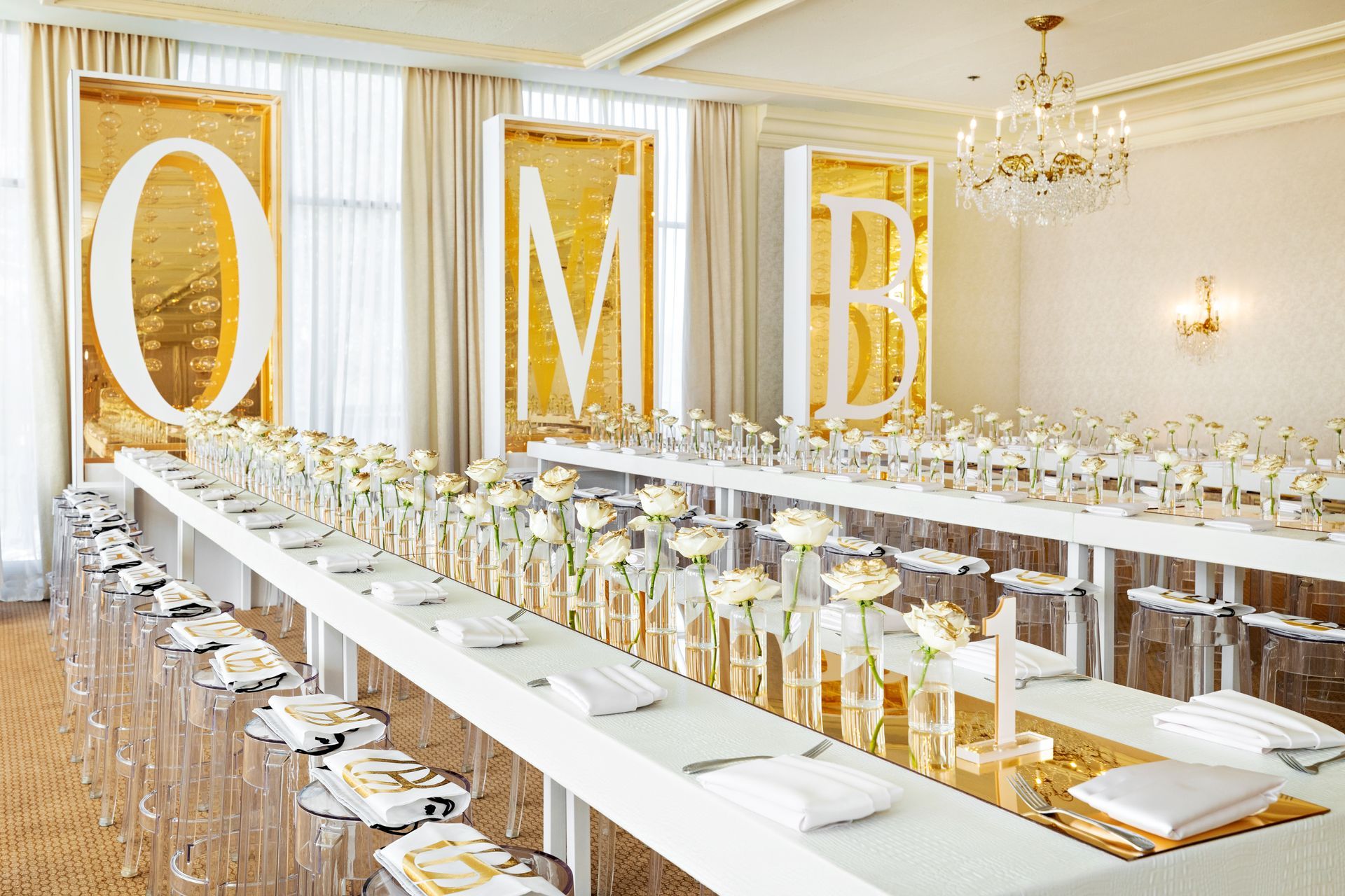 There is a long table with a lot of glasses on it.