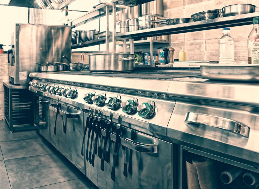 Two Pots Are Sitting on Top of a Stove in a Kitchen — Commercial Kitchens Direct in Unanderra, NSW