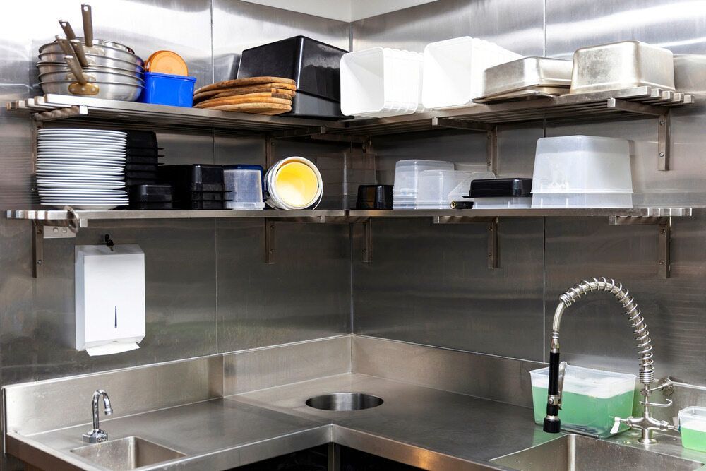 A Kitchen Counter With a Loaf of Bread and a Pan on It — Commercial Kitchens Direct in Shoalhaven, NSW