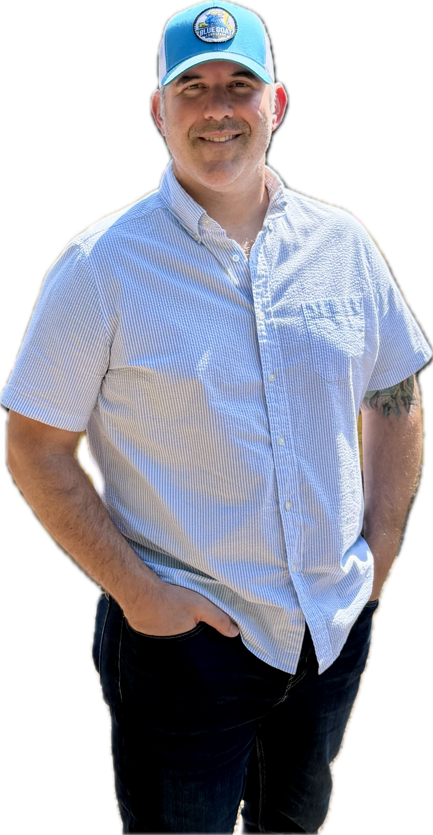 A smiling person with arms crossed, wearing a light blue button-down shirt, isolated against a white background.
