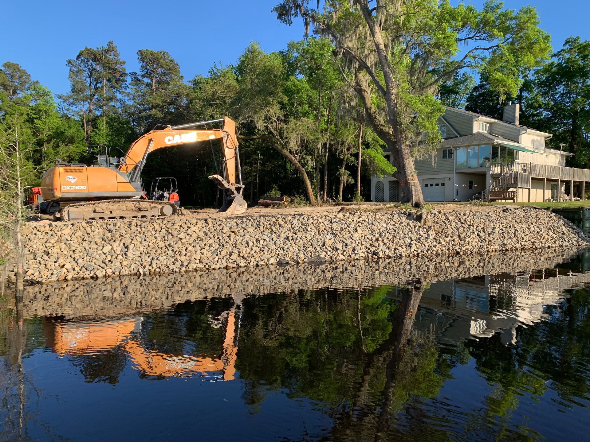 A tractor is cutting down a tree in the woods