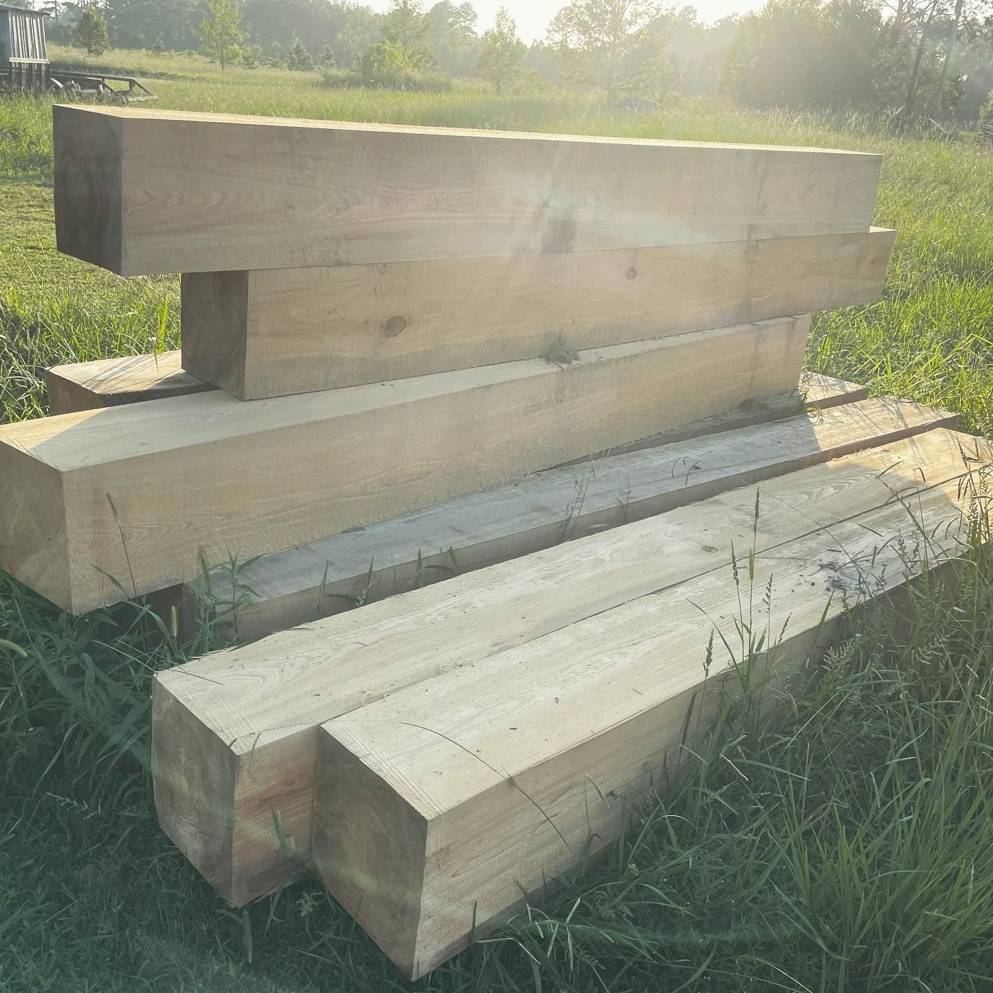Several pieces of wood are stacked on top of each other in the grass