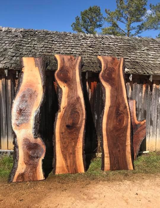 Four pieces of wood are sitting in front of a wooden building. Four pieces of wood are sitting in front of a wooden building.