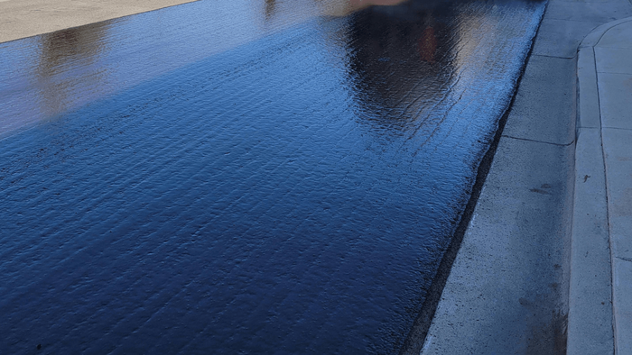 freshly sealed asphalt driveway