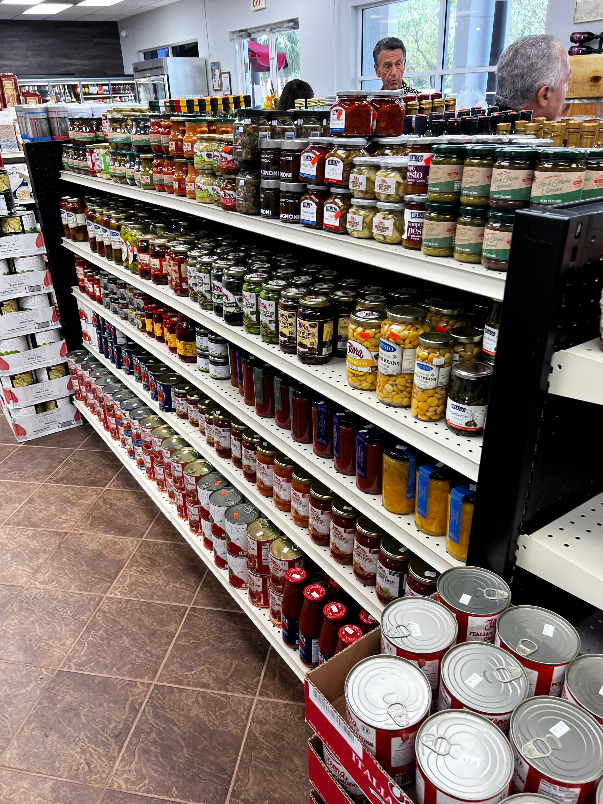 A grocery store aisle filled with canned goods and jars.