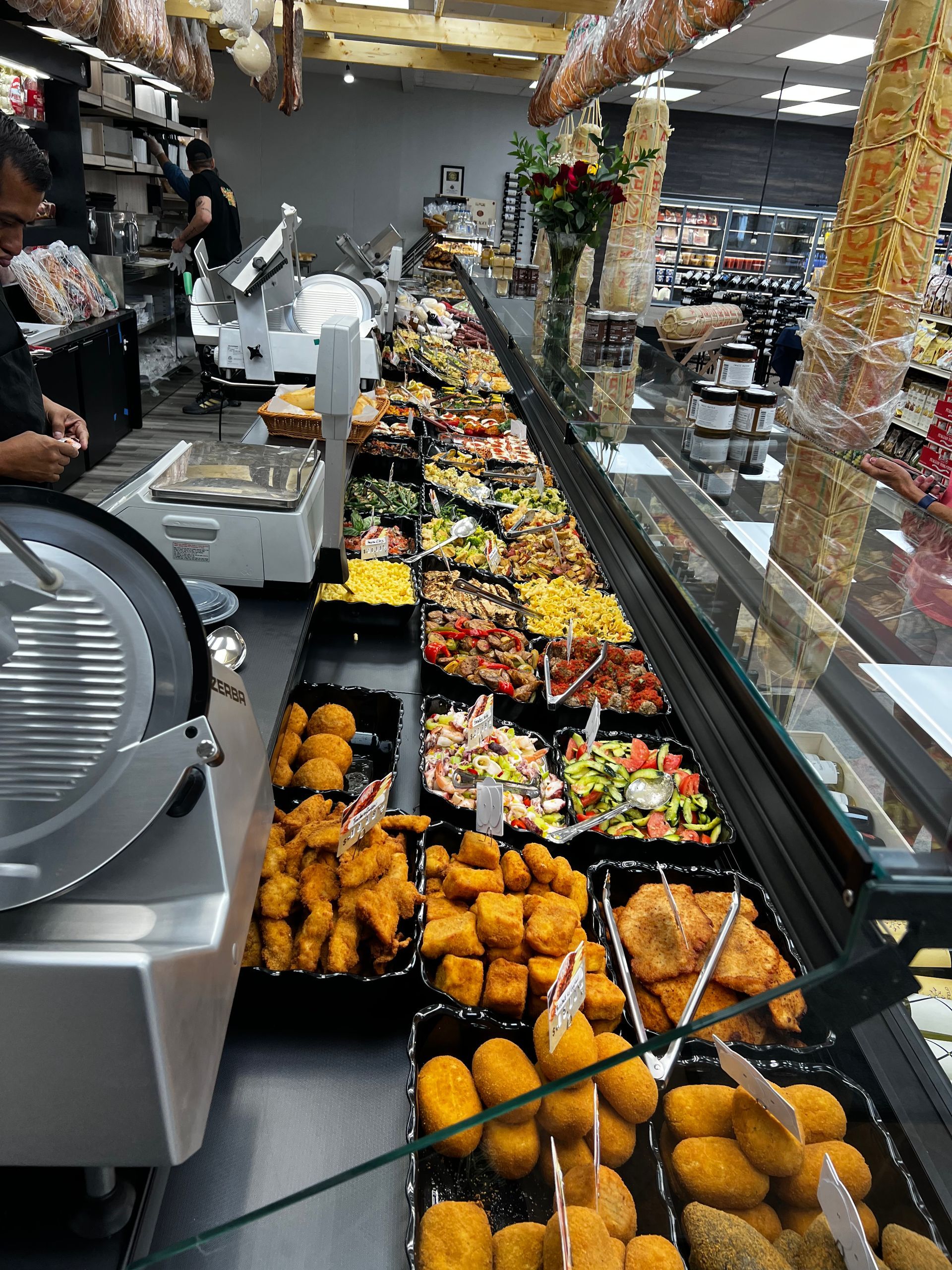 A display case in a grocery store filled with lots of food.