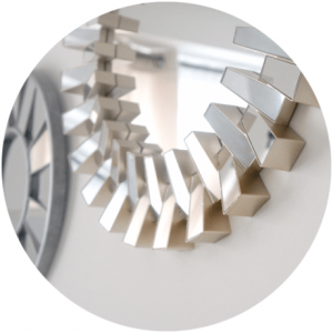 Decorative mirror with a geometric design in a bright room.