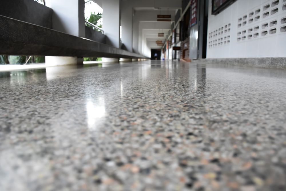 Polished concrete hallway floor with reflective surface.