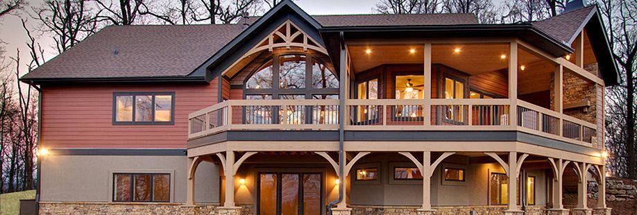 A large house with a large porch and a lot of windows.