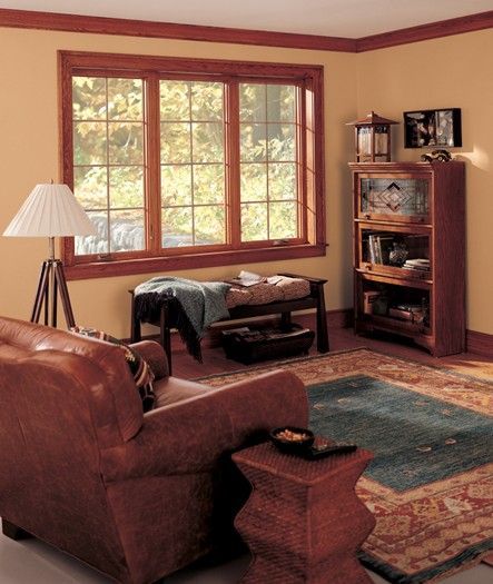 A living room with a couch a chair and a lamp