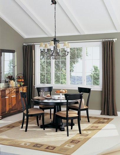 A dining room with a table and chairs and a chandelier
