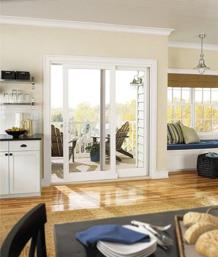 A living room with sliding glass doors leading to a balcony