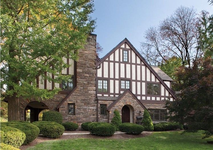 A large house with a large chimney in the middle of it