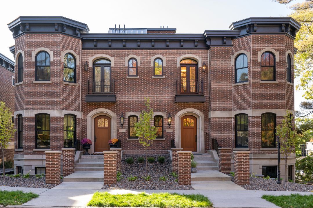 A large brick building with a lot of windows and stairs.