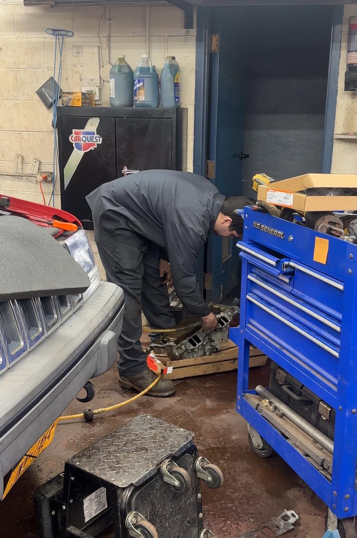 Auto Shop Technician Servicing Vehicle In Garage | Leonard's Auto Service