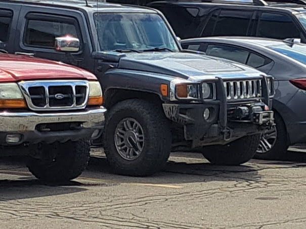 Hummer And Truck Parked Outside Auto Shop | Leonard's Auto Service