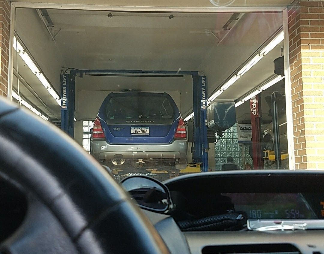 Vehicle On Lift Inside Service Bay | Leonard's Auto Service