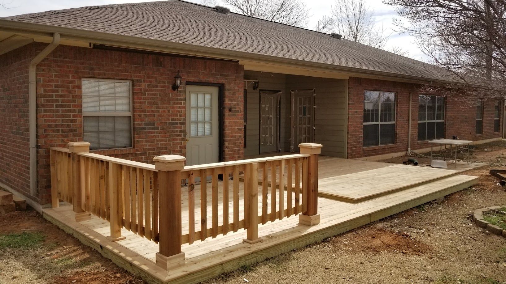 Brick house with a wooden wheelchair ramp and front porch