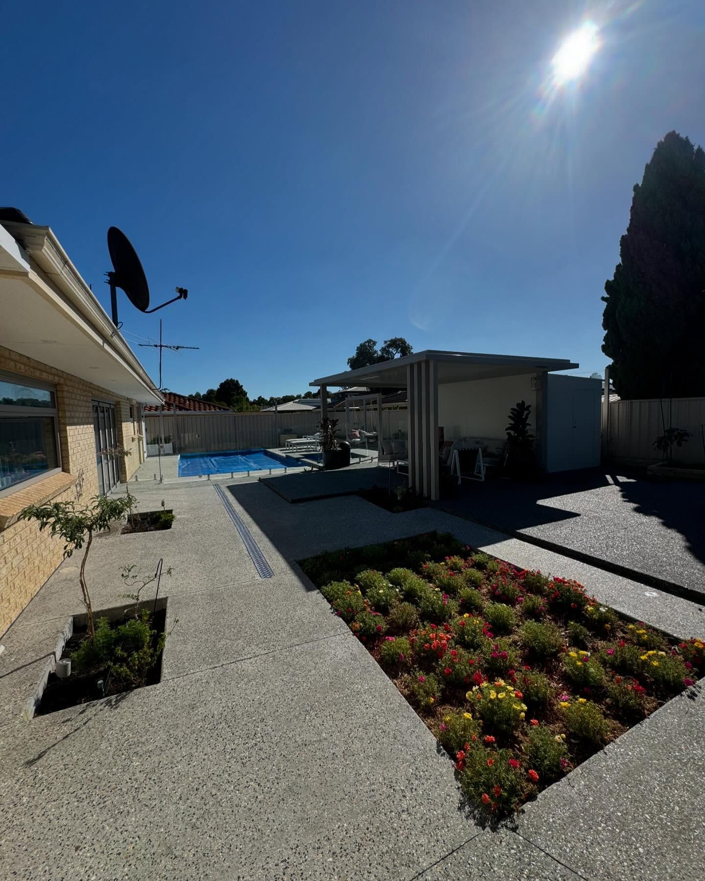 Exposed aggregate path around pool and garden edging.