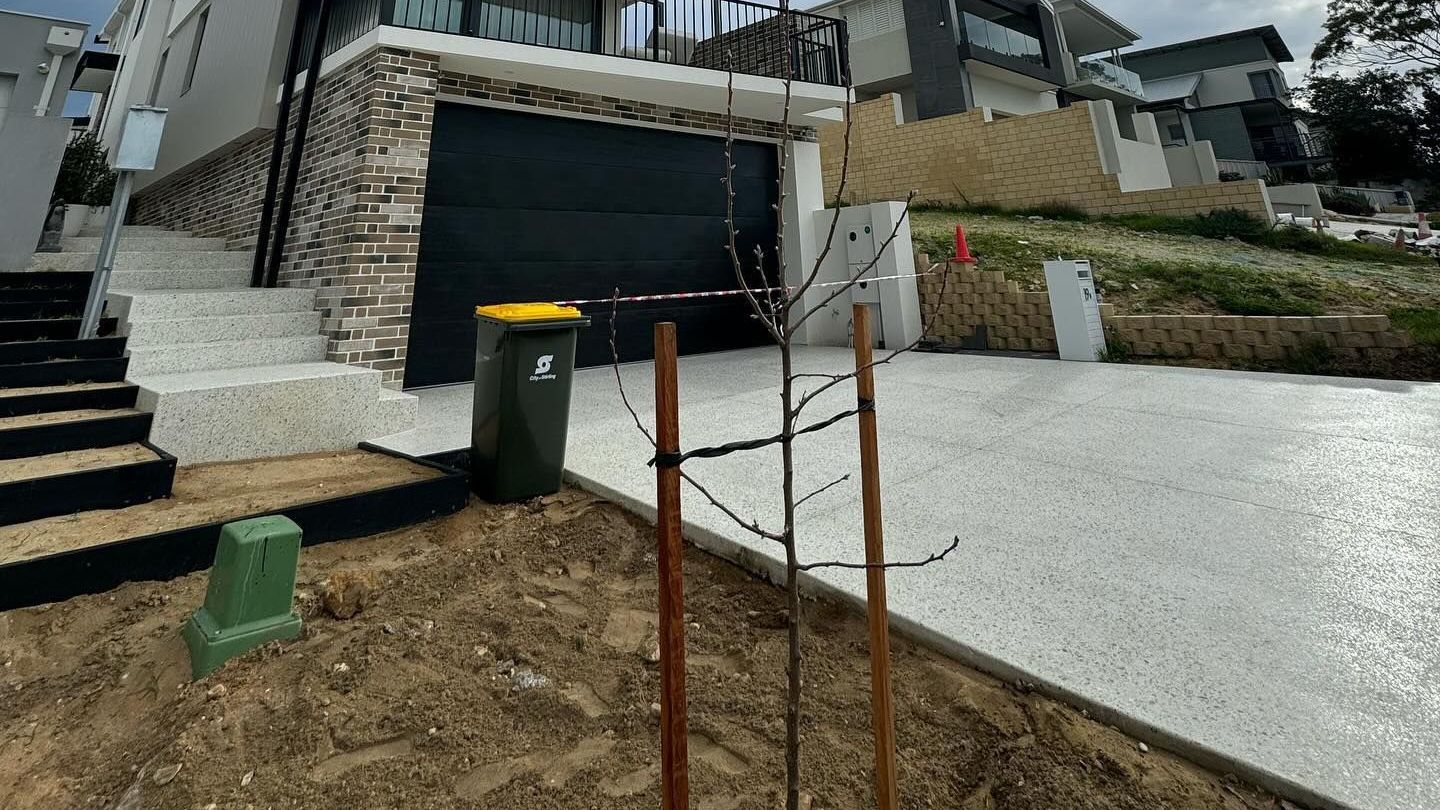 Exposed aggregate driveway and honed stairs for Karrinyup house