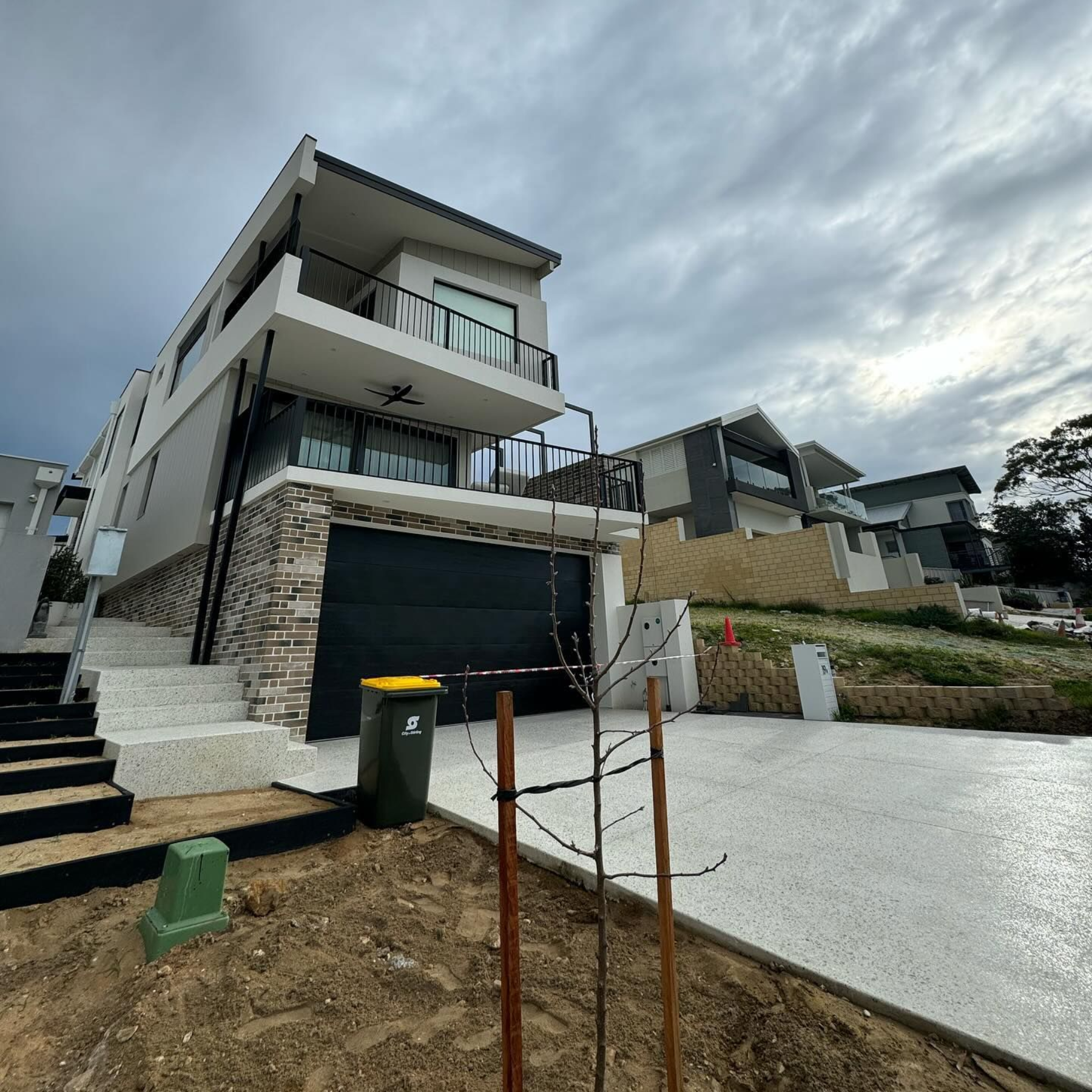 Stunning exposed aggregate driveway & honed stair case by Handmade Concreting in Perth