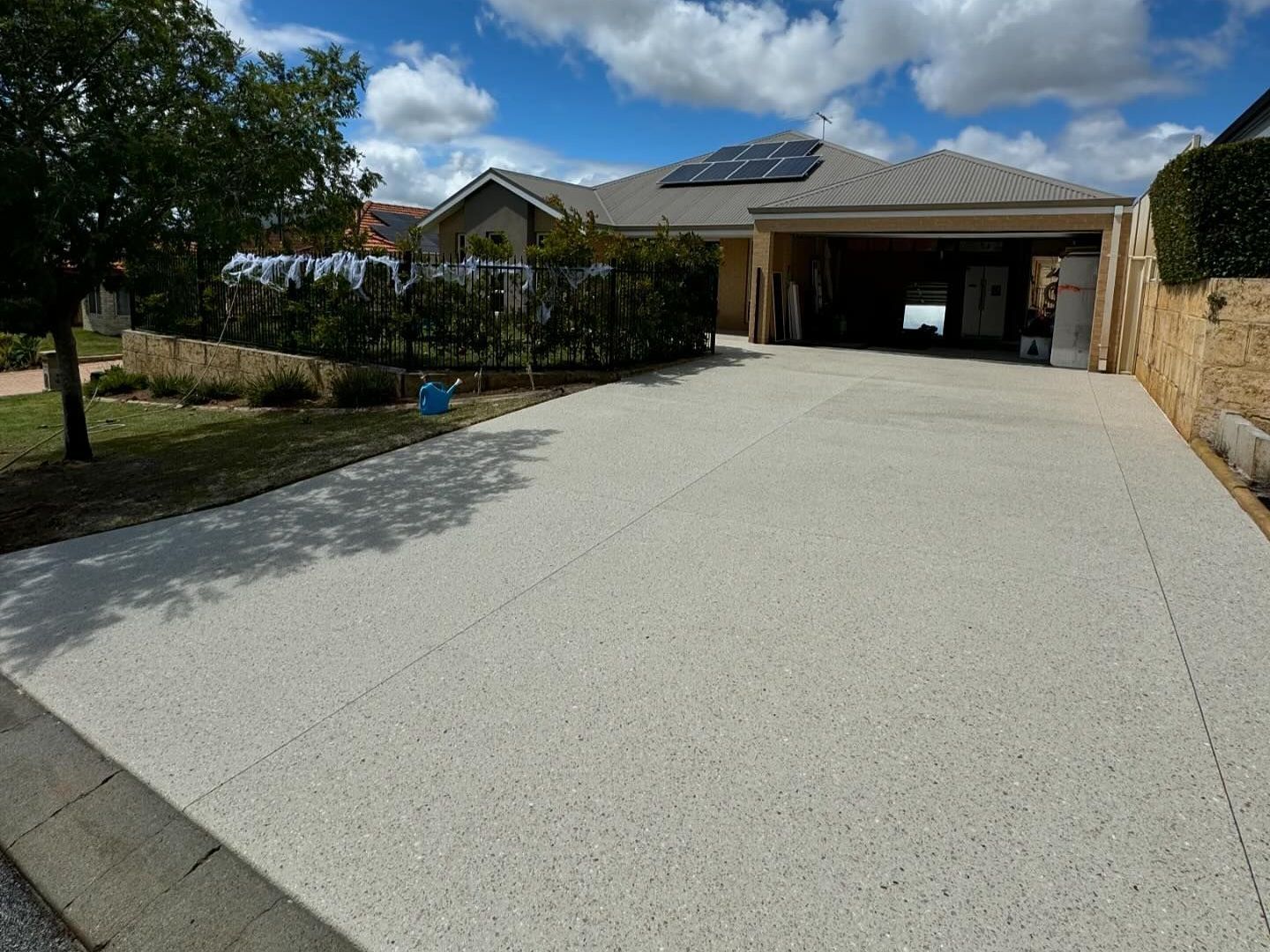 new double wide concrete driveway for existing home in Perth with a uphill driveway