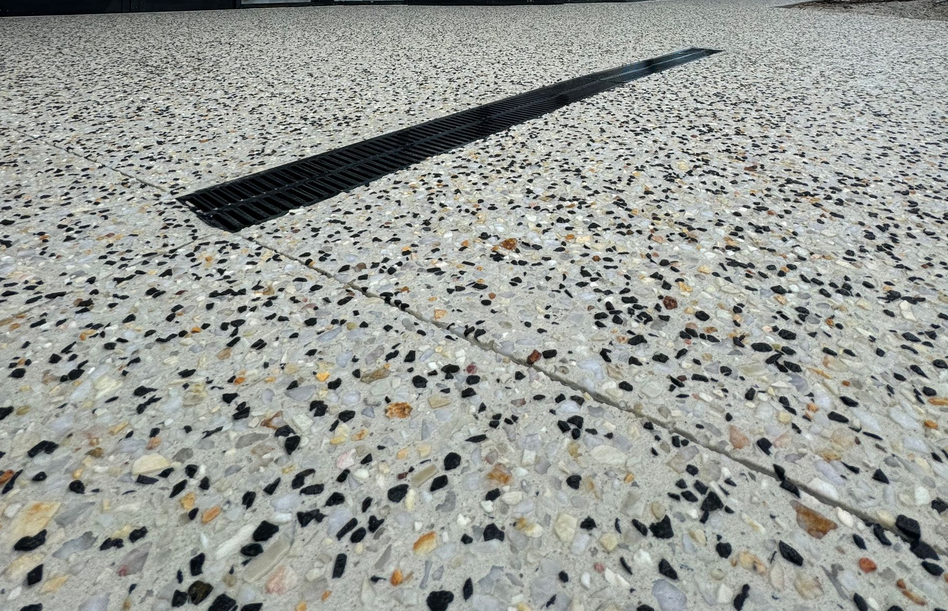 Cosmetic surgery shop front complimented by exposed aggregate concrete driveway with drainage