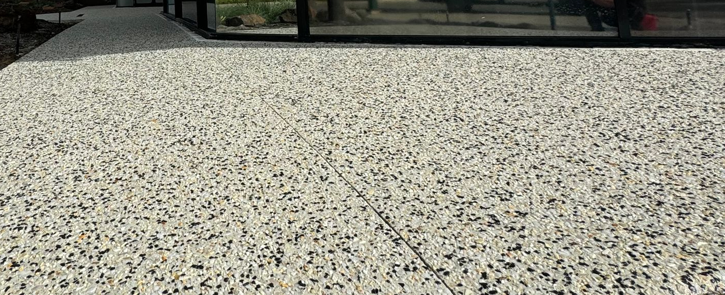 Cosmetic surgery shop front with new exposed aggregate concrete entrance and path.