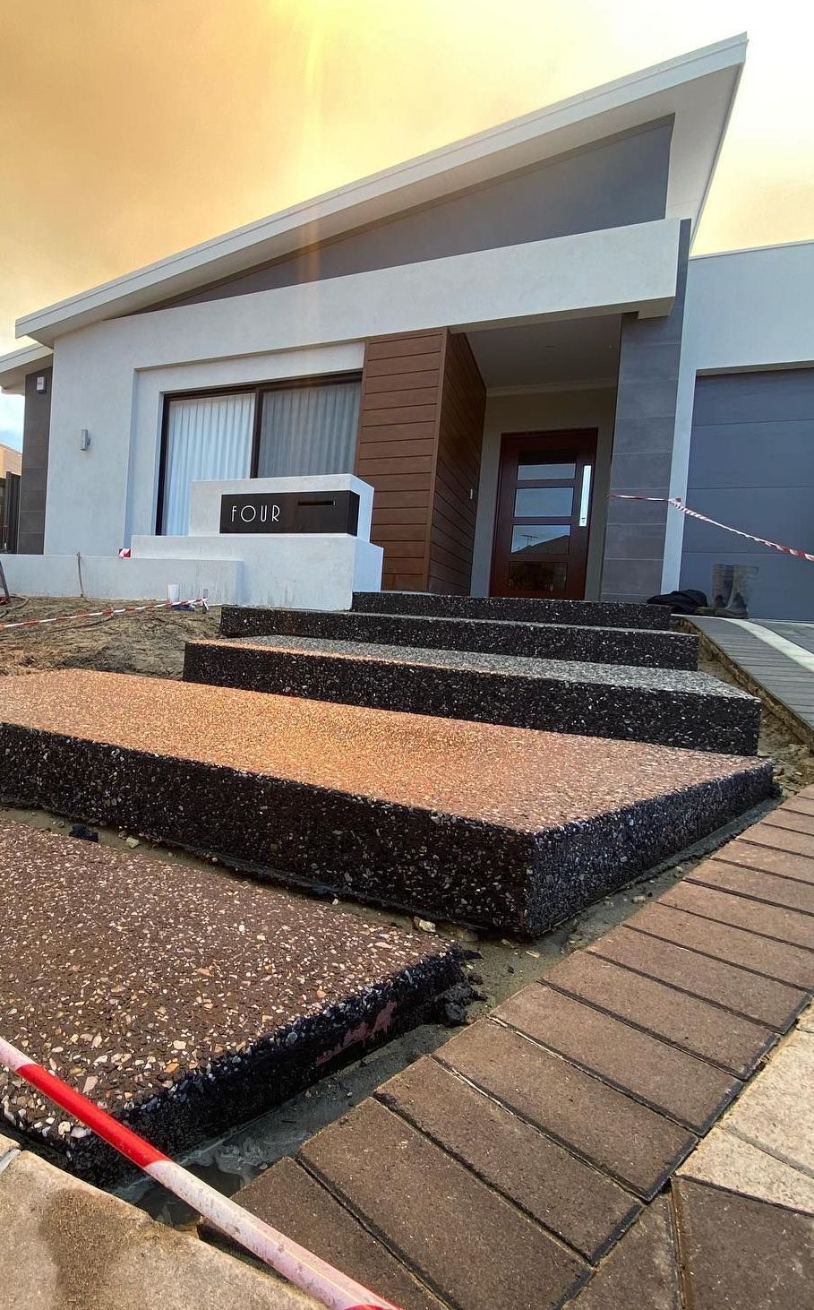Stepping stones up to the front door of a Perth home using exposed aggregate. 