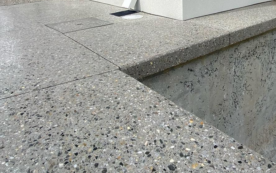 Concrete exposed aggregate pool area with bull nose edging. 