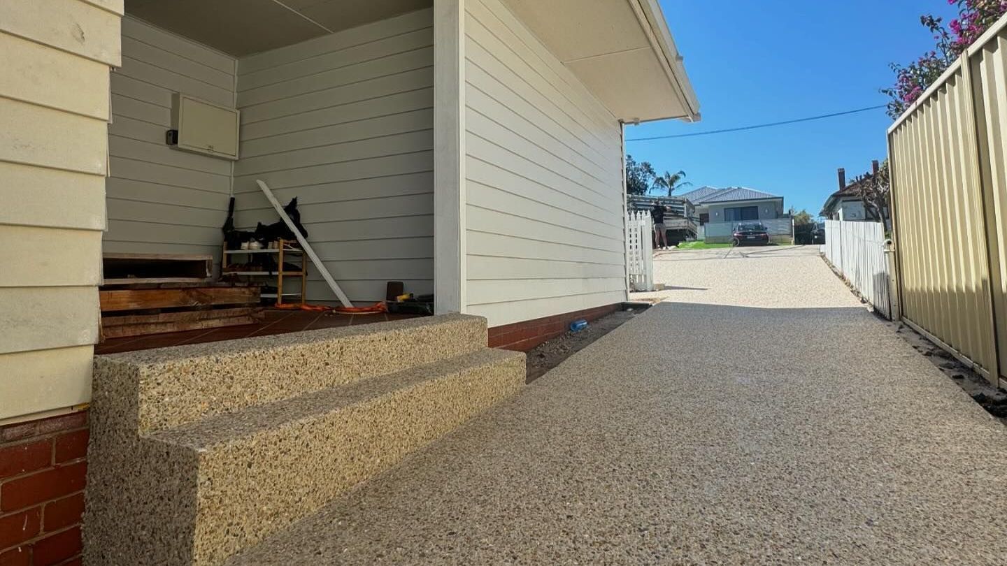 Exposed aggregate driveway with architectural concrete stairs and pathway