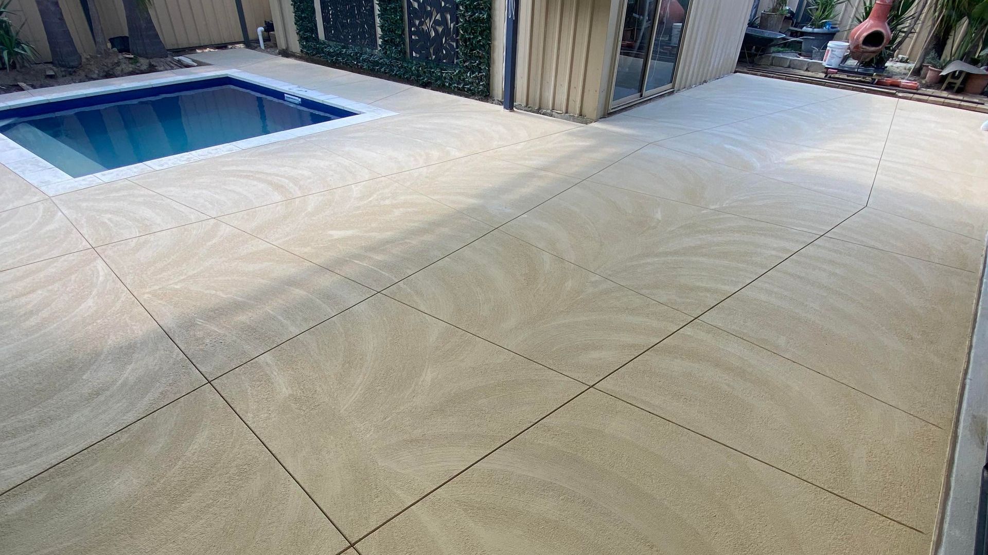 Liquid limestone poured for patio & alfresco with undercover pool.