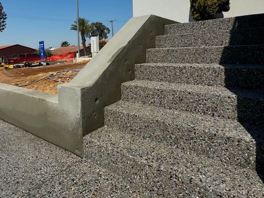 New exposed aggregate stairs in jackwood concrete mix  from Geostone Holcim for Perth home with elevated block.