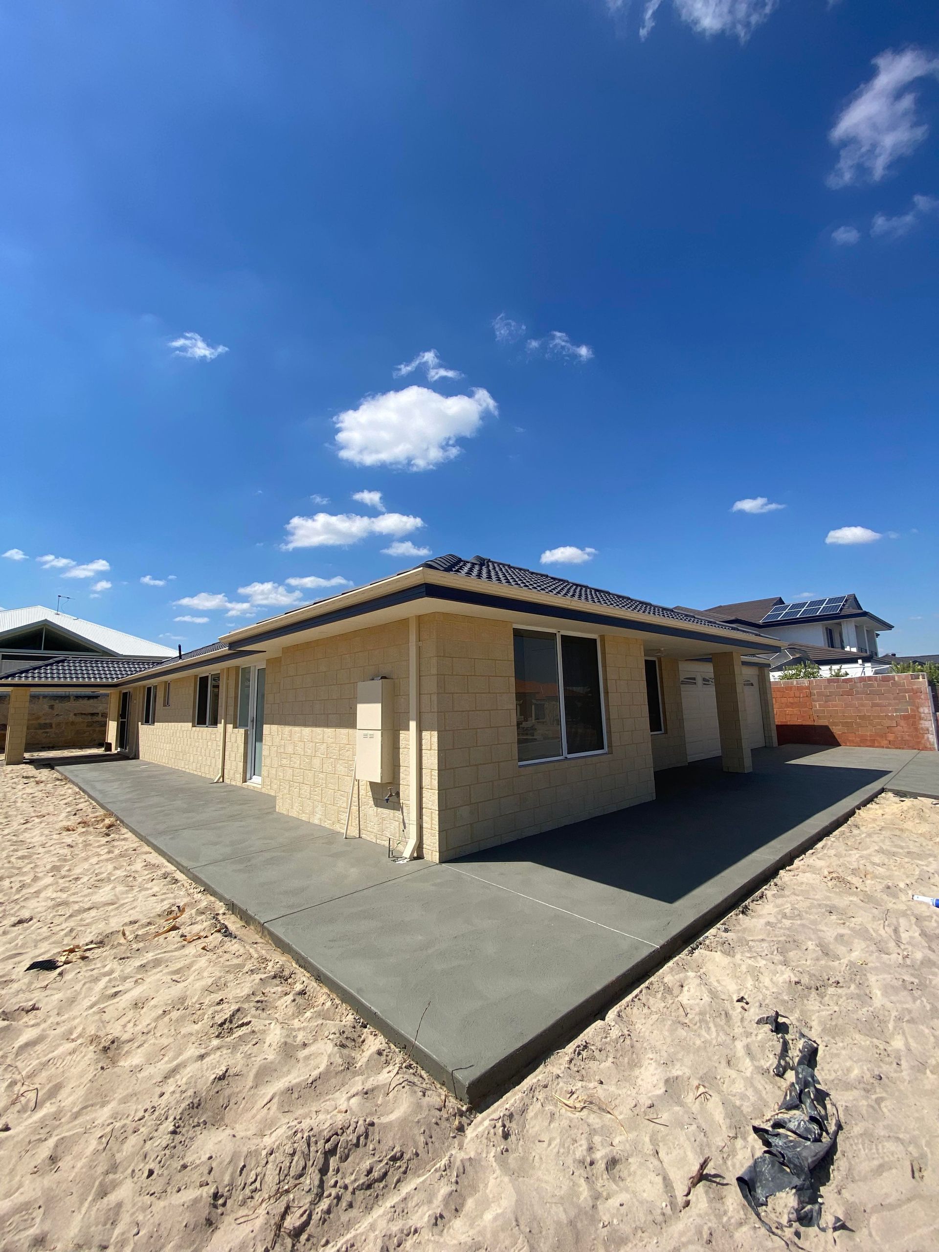 Plain grey concrete walkway around outside of Perth home.