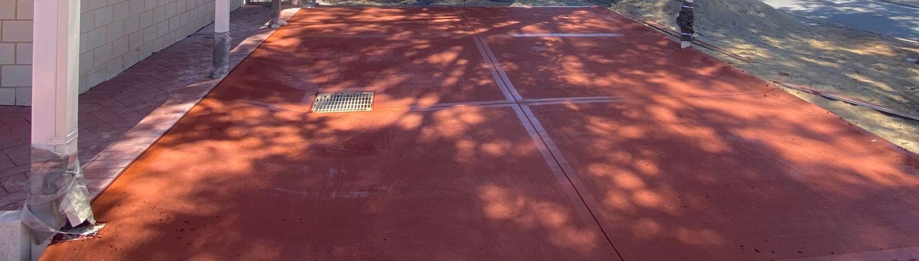 Red Coloured Concrete Driveway on Perth Property