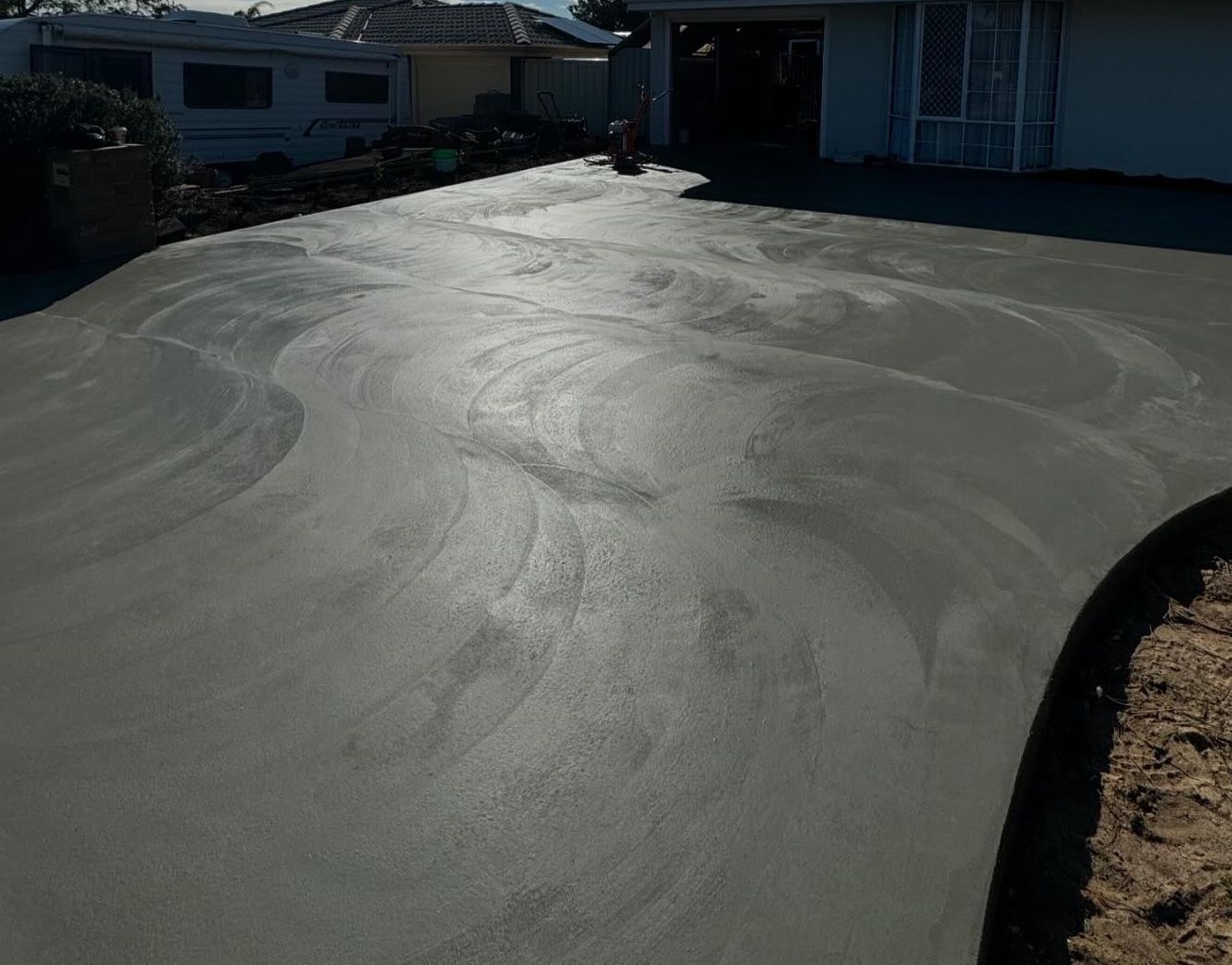 Standard concrete driveway services for apartments in the background